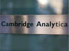 A Cambridge Analytica sign is pictured at the entrance of the building which houses the offices of Cambridge Analytica, in central London on March 21, 2018. Facebook expressed outrage over the misuse of its data as Cambridge Analytica, the British firm at the centre of a major scandal rocking the social media giant, suspended its chief executive.