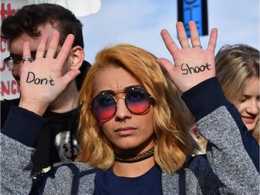 People arrive for the March For Our Lives rally against gun violence in Washington, DC on March 24, 2018. Galvanized by a massacre at a Florida high school, hundreds of thousands of Americans are expected to take to the streets in cities across the United States on Saturday in the biggest protest for gun control in a generation.