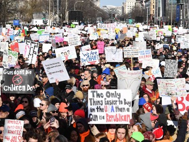 TOPSHOT - People arrive for the March For Our Lives rally against gun violence in Washington, DC on March 24, 2018. Galvanized by a massacre at a Florida high school, hundreds of thousands of Americans are expected to take to the streets in cities across the United States on Saturday in the biggest protest for gun control in a generation.