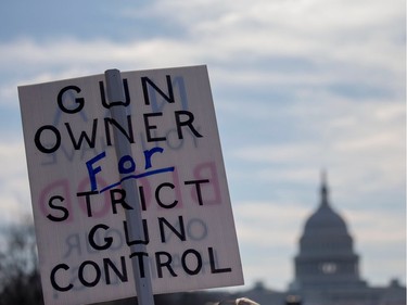 TOPSHOT - People arrive for the March For Our Lives rally against gun violence in Washington, DC on March 24, 2018. Galvanized by a massacre at a Florida high school, hundreds of thousands of Americans are expected to take to the streets in cities across the United States on Saturday in the biggest protest for gun control in a generation.