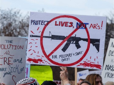 Rally goers carry protest signs during the March for Our Lives Rally in Washington, DC on March 24, 2018.  Galvanized by a massacre at a Florida high school, hundreds of thousands of Americans are expected to take to the streets in cities across the United States on Saturday in the biggest protest for gun control in a generation.