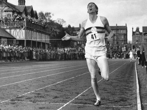 In this May 6, 1954, file photo, British athlete Roger Bannister breaks the tape to become the first man ever to break the four minute barrier in the mile at Iffly Field in Oxford, England.