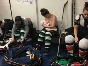 Serah Small breastfeeds her baby half clothed in her hockey gear in a photo posted on Milky Way Lactation Services' Facebook page.