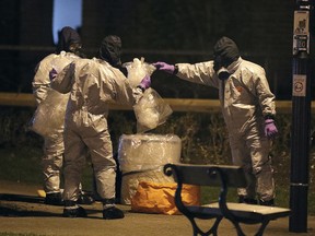 Investigators in protective suits work at the scene in the Maltings shopping centre in Salisbury, England, Tuesday, March 13, 2018. Novichok nerve agents were developed in the Soviet Union near the end of the Cold War.