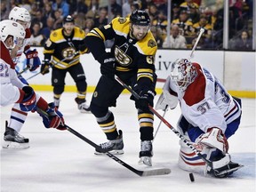 Boston Bruins' Rick Nash (61) battles Montreal Canadiens' Antti Niemi (37) for a rebound during the second period of an NHL hockey game in Boston, Saturday, March 3, 2018.