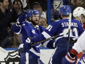 Tampa Bay Lightning right wing Nikita Kucherov, of Russia, left celebrates with Steven Stamkos after scoring against the Montreal Canadiens during the third period of an NHL hockey game Saturday, March 10, 2018.