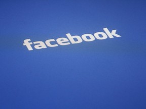 A Facebook logo is displayed on the screen of an iPad in a Wednesday, May 16, 2012 file photo taken in New York. The Canadian whistleblower at the centre of an international scandal that saw the Trump campaign capitalize politically from the use of private Facebook information got his start in politics with the Liberal Party of Canada.