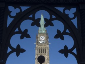 The Peace Tower is framed through a gate on Parliament Hill in Ottawa on January 21, 2016.