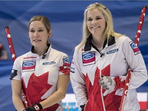 Canada skip Jennifer Jones, right, and third Kaitlyn Lawes chat as they face the Czech Republic during the World Women's Curling Championship in North Bay, Ont., Saturday, March 17, 2018.