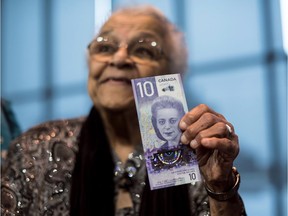 Wanda Robson, sister of Viola Desmond, holds the new $10 bank note featuring Desmond during a press conference in Halifax on March 8, 2018.