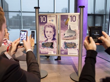 People take photos of the new $10 bank note featuring Viola Desmond following the bill's unveiling in Halifax on Thursday, March 8, 2018. Desmond is the first Canadian woman to be featured on a regularly circulating bank note.