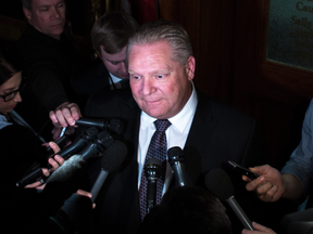 Ontario PC leader Doug Ford talks to reporters after a caucus meeting at Queen's Park in Toronto on March 20, 2018.