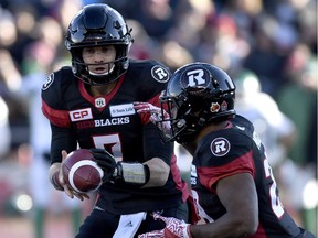 Ottawa Redblacks quarterback Trevor Harris passes the ball to William Powell.