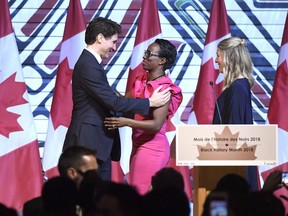 Prime Minister Justin Trudeau is welcomed by two female colleagues, Parliamentary Secretary to the Minister of International Development Celina Caesar-Chavannes, and Minister of Canadian Heritage Mélanie Joly, during a Black History Month reception at the Museum of History in February.