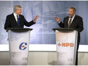 Conservative Leader Stephen Harper, left, exchanges words with NDP Leader Tom Mulcair during the French-language debate on Thursday, September 24, 2015, in Montreal.