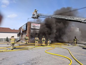 Firefighters battle a two-alarm blaze in a strip mall on St. Joseph Boulevard near Grey Nuns Drive in Orléans Saturday, March 31.