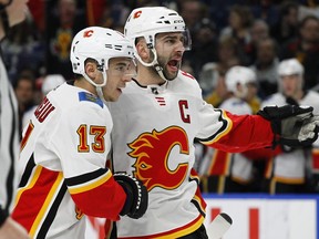 Calgary's Johnny Gaudreau (13) and Mark Giordano celebrate a goal during the second period of Wednesday's game in Buffalo.