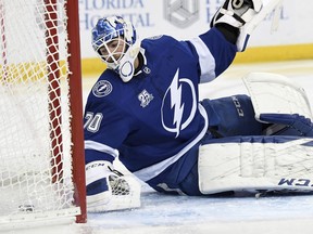 The puck gets past Tampa Bay Lightning goaltender Louis Domingue (70) for an Edmonton Oilers goal during the first period of an NHL hockey game Sunday, March 18, 2018, in Tampa, Fla.