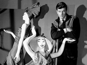 FILE - In this Feb.1 1952 file photo, French fashion designer Hubert de Givenchy poses with mannequins in his shop in Paris.