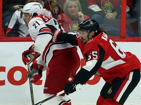 Ottawa Senators Erik Karlsson (65)pushes Carolina Hurricanes' Lee Stempniak (21)during first period NHL hockey action in Ottawa, Saturday, March 24, 2018.