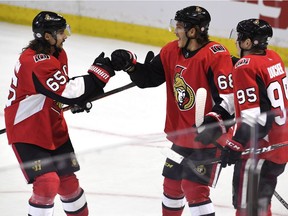 Senators winger Mike Hoffman (68) celebrates with Erik Karlsson, left, and Matt Duchene after scoring the overtime game winner against the Sabres on Feb. 15.