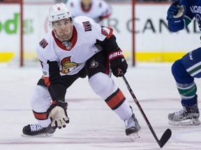 The Senators' Chris Wideman reaches for a puck during an Oct. 10 game against the Canucks.
