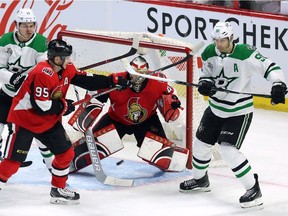 Stars centre Jason Spezza, right, and the Senators' Matt Duchene (95) attempt to deflect the puck in front of Senators goaltender Craig Anderson uring the first period of Friday's game.