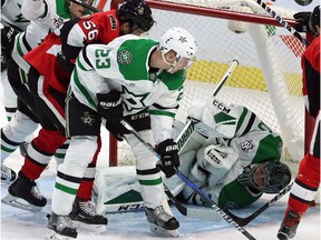 Stars goaltender Ben Bishop smothers the puck to halt play as defenceman Esa Lindell (23) and Senators winger Magnus Paajarvi (56) look on during the second period.