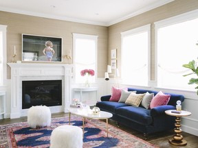 This undated photo provided by Jessica McClendon shows a living room designed by interior designer McClendon. The richness of a royal blue sofa and gold-toned accessories is balanced by the softness of neutral walls.