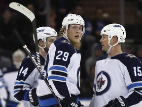 Winnipeg Jets right wing Patrik Laine of Finland looks down the ice after scoring the third of his three goals on an empty New York Rangers net during the third period of an NHL hockey game in New York.