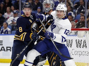 Buffalo Sabres defenceman Casey Nelson (8) and Toronto Maple Leafs forward Patrick Marleau (12) battle for position Thursday, March 15, 2018, in Buffalo, N.Y. (AP Photo/Jeffrey T. Barnes)