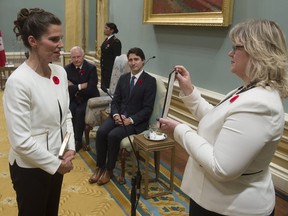 Governor General David Johnston and Prime Minister Justin Trudeau look on as Kirsty Duncan is sworn in as the Minister of Science during ceremonies at Rideau Hall Wednesday Nov.4, 2015 in Ottawa.