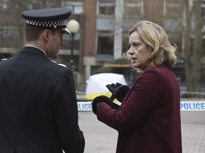 Britain's Home Secretary Amber Rudd talks with Wiltshire Police Assistant Chief Constable Kier Pritchard during a visit to the scene at the Maltings shopping centre in Salisbury where former Russian double agent Sergei Skripal and his daughter were found critically ill after exposure to a nerve agent, Friday March 9, 2018.