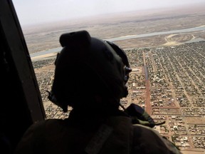 Canada's contribution to the UN peacekeeping mission in Mali is expected to include up to six helicopters and a sizeable female presence, all of which will be operating in an area rife with Islamic terrorists, Tuareg rebels - and an unforgiving climate. A French soldier stands inside a military helicopter during a visit by French President Emmanuel Macron to the troops of Operation Barkhane, France's largest overseas military operation, in Gao, northern Mali, Friday, May 19, 2017.
