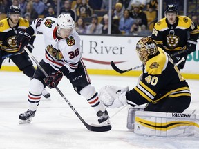 Boston Bruins' Tuukka Rask (40), of Finland, blocks a shot by Chicago Blackhawks' Matthew Highmore (36) during the first period of an NHL hockey game in Boston, Saturday, March 10, 2018.