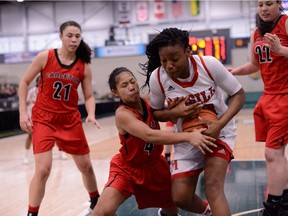 Jenjen Abella of the Ravens tries to steal the ball from Ruth Tshikudi-Tshila of the Martlets during the second half of Saturday's game in Regina. Credit: Arthur Ward/Arthur Images