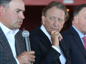 Senators GM Pierre Dorion, left, and owner Eugene Melnyk at a media conference last September.