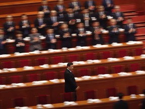 Delegates applaud as President Xi Jinping arrives for a plenary session of China's National People's Congress (NPC) at the Great Hall of the People in Beijing on Tuesday, March 13, 2018. On Sunday, China's legislature scrapped a two-term limit on the presidency, paving the way for Xi to rule for as long as he wants.