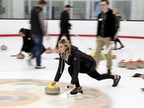 In this March 4, 2018 photo, participants in an all-ages group learn how to curl at the Aksarben Curling Club in Omaha, Neb. Curling clubs across the United States have seen a major uptick in interest in the sport in the wake of the U.S. men winning the gold medal at the Winter Olympics. The Aksarben Curling Club in Omaha reports that 1,000 people will participate in its learn-to-curl events this winter and spring. That is more than twice as many as in a normal year.