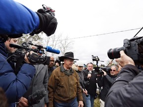 FILE - In this Tuesday, Dec. 12, 2017, file photo, journalists follow U.S. Senate candidate Roy Moore as he arrives to cast his vote in Gallant, Ala. December's U.S. Senate election in Alabama was rife with fake online reports in support of Moore, who lost the race to Democrat Doug Jones amid allegations that Moore had sexual and romantic contact with teens when he was a prosecutor in his 30s.