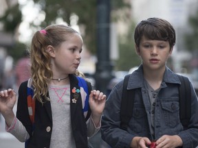 This image released by Netflix shows Darby Camp, left, and Gabriel Bateman a scene from "Benji." (Netflix via AP)