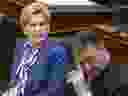 Ontario Premier Kathleen Wynne looks on next to Provincial Finance Minister Charles Sousa as she listens to Ontario Lt.-Governor Elizabeth Dowdeswell, not shown, deliver the Speech from the Throne at the Ontario Legislature, in Toronto on Monday, March 19, 2018.