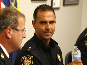 Thursday, Sept. 29, 2011 — Ottawa police Insp. Samir Bhatnagar speaks to Supt. Tim Mackin, interim chief of the RCMP's organized crime and border integrity division during a press conference in Ottawa.