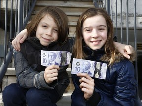 Abraham, left, and Grace Brosha are  photographed outside their home in Ottawa Wednesday March 21, 2018. Children from all over the city gather four times a year, each bringing $10 of their own spending money. They listen to three of their peers present on three different charities or non-profit organizations. After the presentations, all of the children vote on the organization of their choice, and the organization with the most votes gets the pooled donation from all of the children.  Tony Caldwell