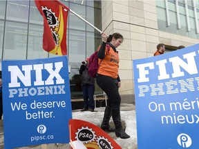 Public servants participate in a rally rally against the Phoenix payroll system outside the offices of the Treasury Board of Canada in Ottawa on Wednesday, Feb. 28, 2018.