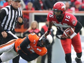 Josh Johnson just misses Calgary Stampeders quarterback Dominique Davis while playing for the B.C. Lions in 2015.