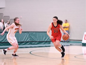 The Ravens' Elizabeth Leblanc, right, dribbles the basketball up the court against the Dinos during a first-round game in Regina on Thursday. Arthur Ward/Arthur Images