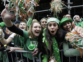 People cheer during a St. Patrick's Day Parade in New York.