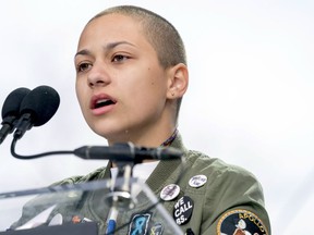 FILE -- In this March 24, 2018 file photo, Emma Gonzalez, a survivor of the mass shooting at Marjory Stoneman Douglas High School in Parkland, Fla., closes her eyes and cries as she stands silently at the podium for the amount of time it took the Parkland shooter to go on his killing spree during the "March for Our Lives" rally in support of gun control in Washington. A doctored photo online appeared to show Gonzalez tearing up the U.S. Constitution. , Saturday, March 24, 2018.