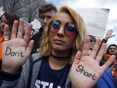 Daisy Hernandez, 22, of Stafford, Va., wrote "Don't Shoot," on her hands during the "March for Our Lives" rally in support of gun control, Saturday, March 24, 2018, in Washington.